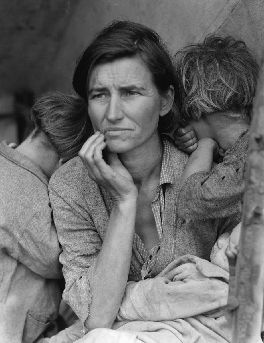 Dorothea Lange's Migrant Mother: a seated woman with her hand at her chin, two children resting on her shoulders and a baby in her lap