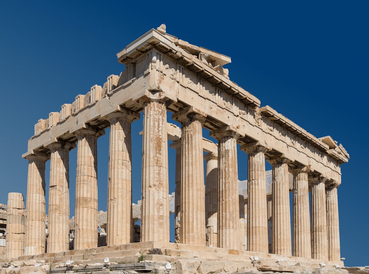 The Parthenon on the Acropolis of Athens seen from the north-west, golden marble columns against a deep blue sky